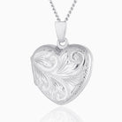 Petite 9 ct white gold heart locket engraved all over with a foliate design, on a 9 ct white gold curb chain