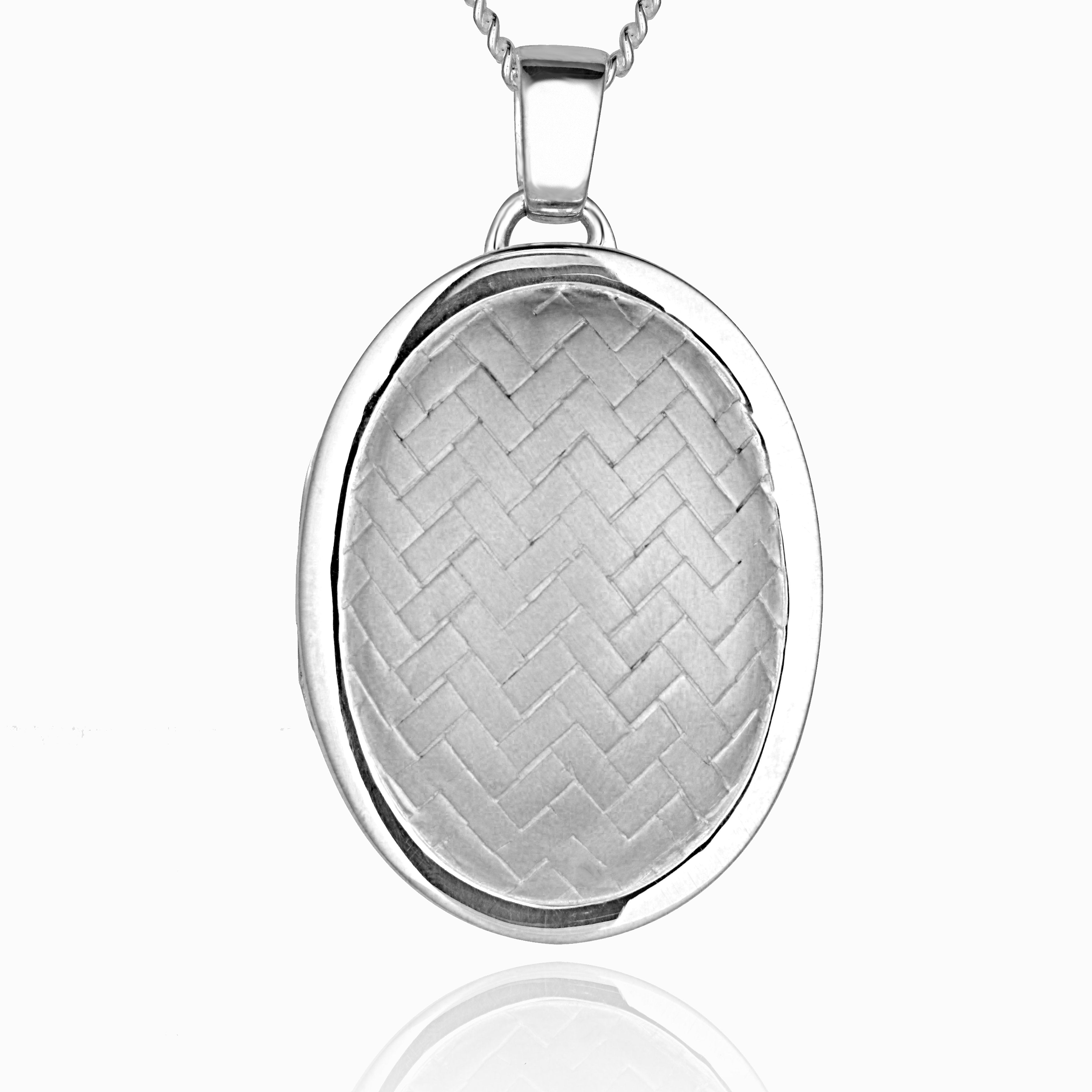 sterling silver oval locket with a herringbone design on the front, on a sterling silver curb chain
