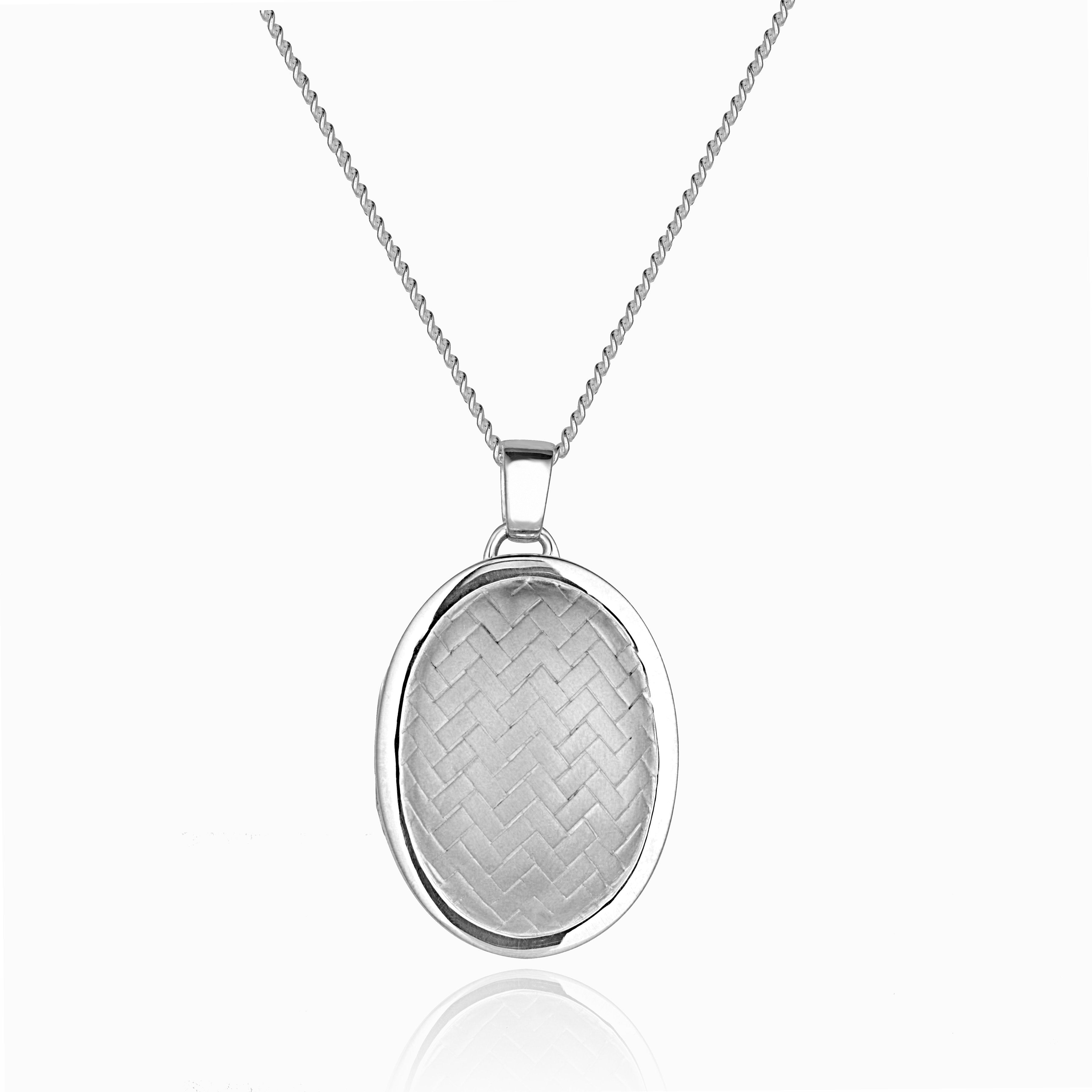 sterling silver oval locket with a herringbone design on the front, on a sterling silver curb chain