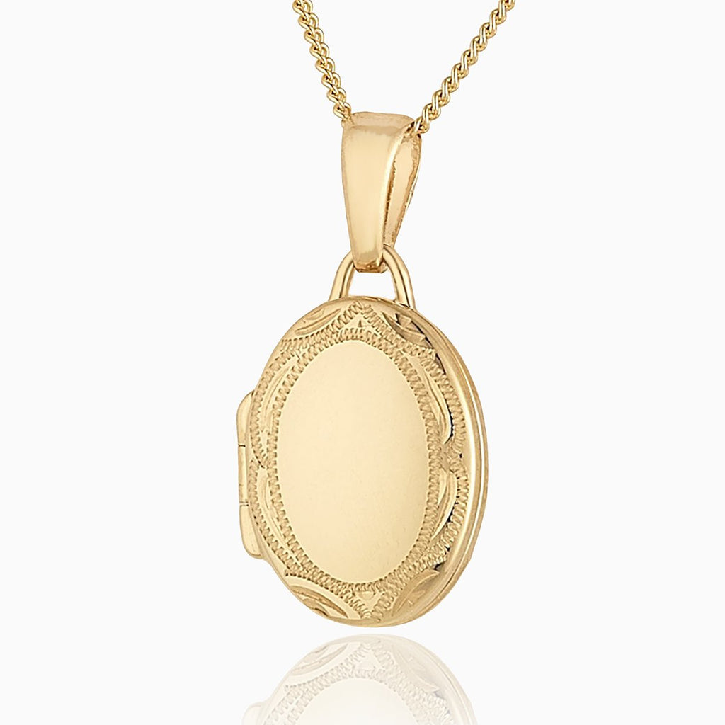 9 ct gold oval locket with an engraved border on a 9 ct gold curb chain