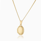 9 ct gold oval locket with an engraved border on a 9 ct gold curb chain