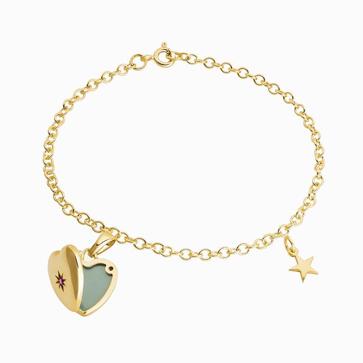 A 9 ct gold bracelet set with a 9 ct gold and ruby heart locket and a 9 ct gold star charm.