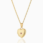 Petite 9 ct gold heart locket set with a ruby on a 9 ct gold rope chain.