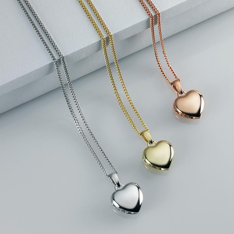 This is a collection of tiny white gold, yellow gold and rose gold tiny heart locket.