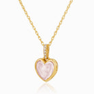 18 ct gold petite geart locket, reversibe with pink rose quartz on one side and diamonds on the other side. The bail also set with diamonds front and back. On a n 18 ct gold rope chain