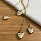 4 9 ct gold heart lockets, sech set with a different stone. Ond diamond, one emerald, one ruby and 1 sapphire.