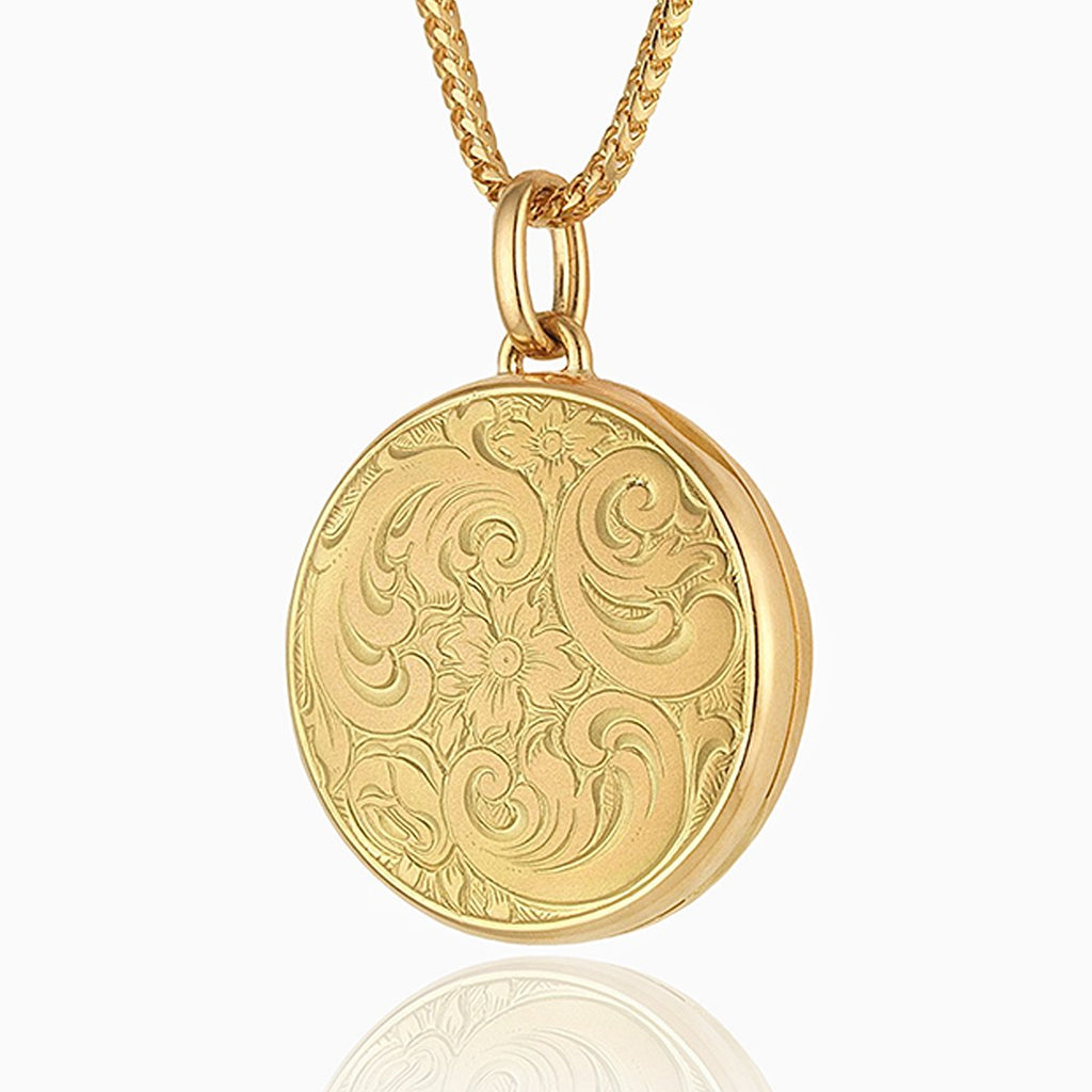18 ct gold round locket engraved with a floral design on an 18 ct gold franco design
