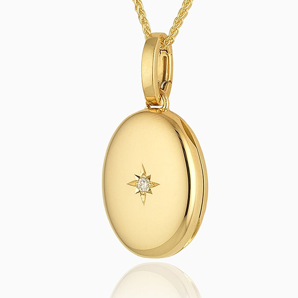 18 ct gold oval locket star set with a diamond in the middle