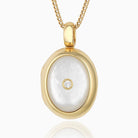 18 ct gold oval locket set with mother of pearl and a central diamiond, on an 18 ct gold franco chain