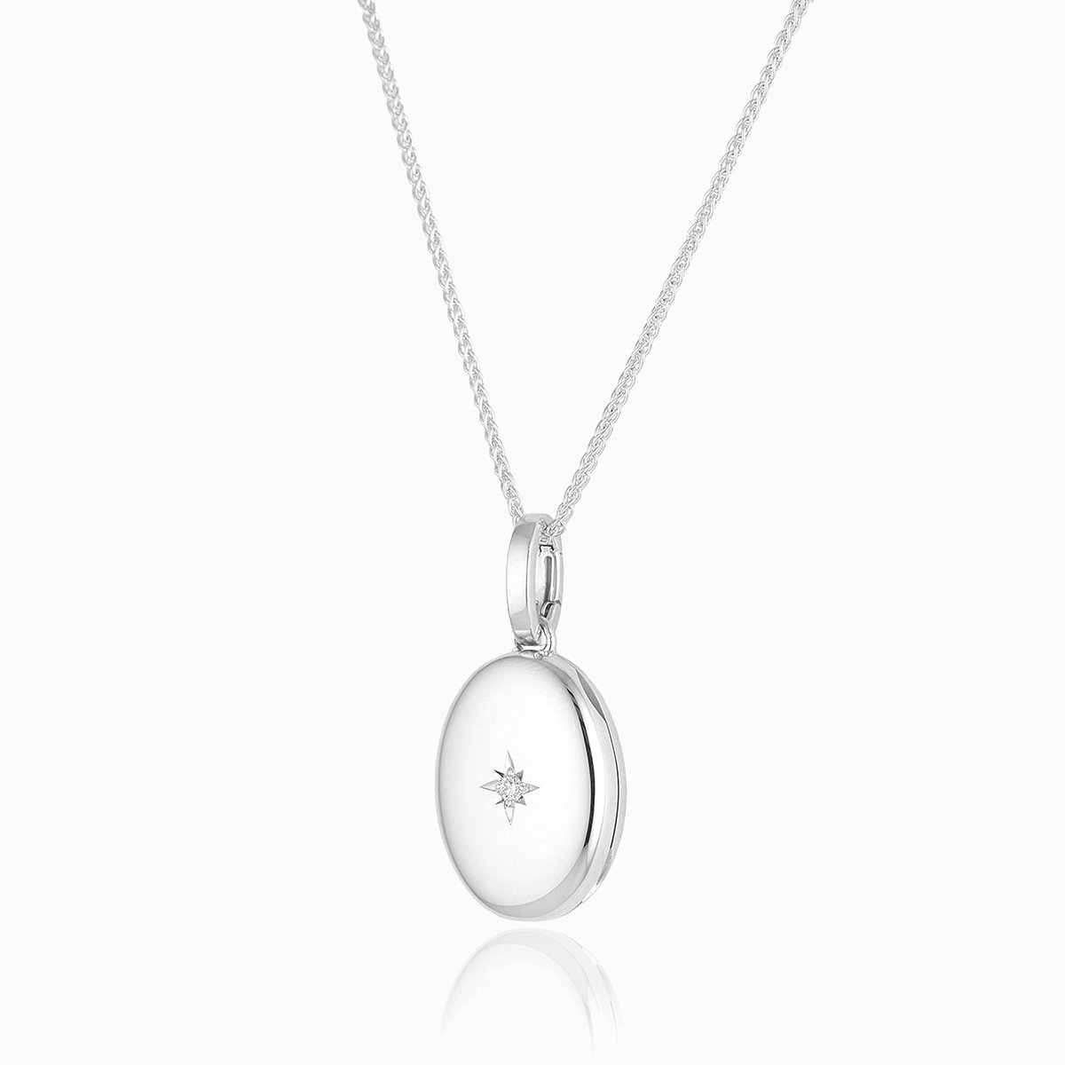 18 ct white gold oval locket star set with a diamond on an 18 ct white gold spiga chain
