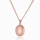 Front shot of a premium 9 ct rose gold foliate border locket set on matching 9 ct rose gold curb chain.