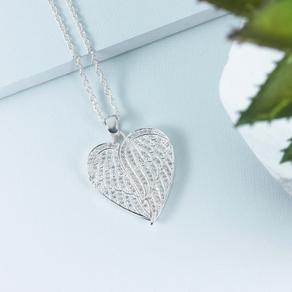 heart shaped sterlinf silver locket covered all over with cubic zirconia stones, and opening with 2 wings
