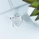 open view of heart shaped sterlinf silver locket covered all over with cubic zirconia stones, and opening with 2 wings