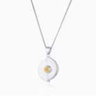 Circular 9 ct white gold locket set with a yellow citrine on a 9 ct white gold curb chain