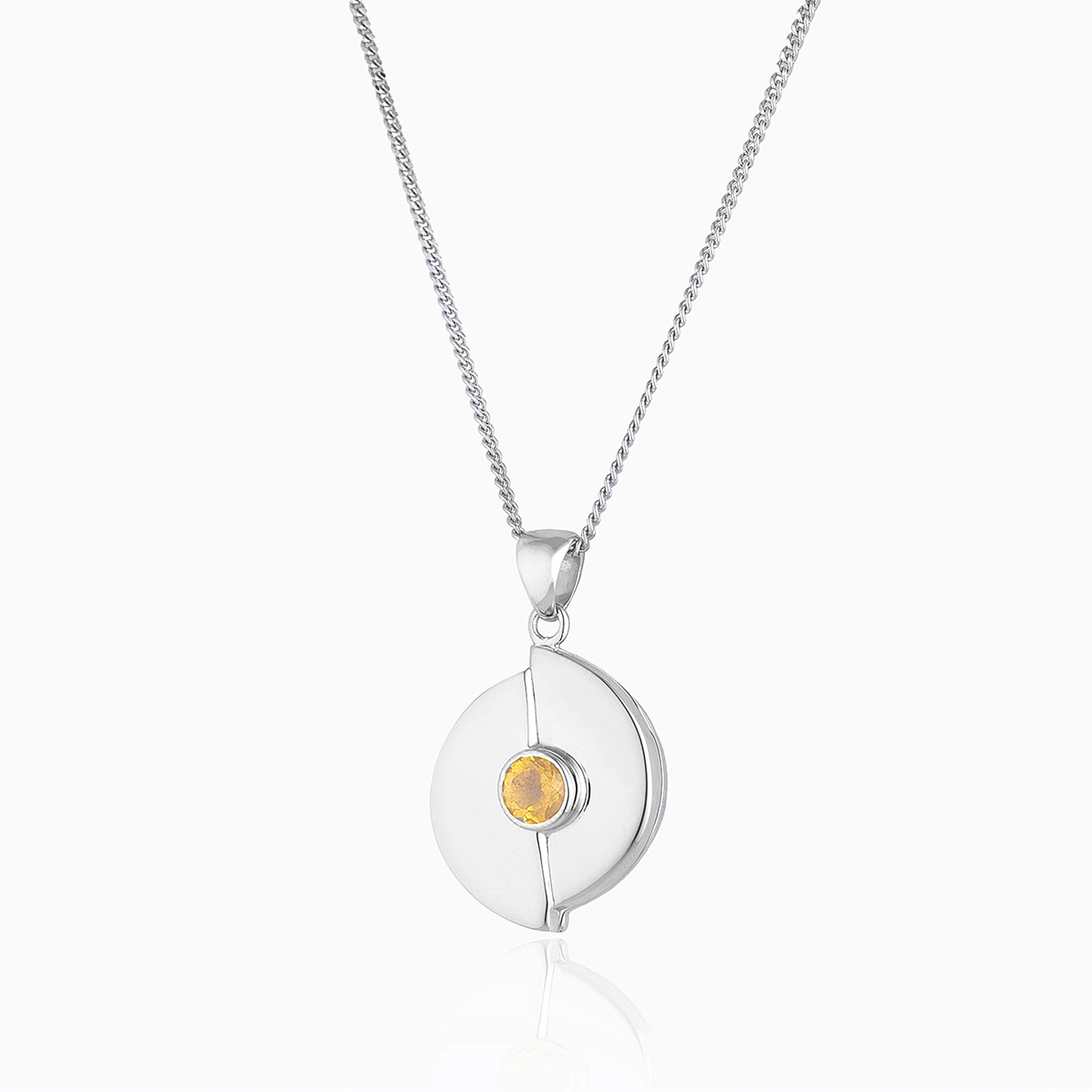 sterling silver round locket set with. yellow citrine, on a sterling silver curb chain